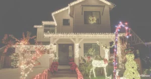 Photo of a nicely decorated house with lights and christmas decor such as a reindeer lit up