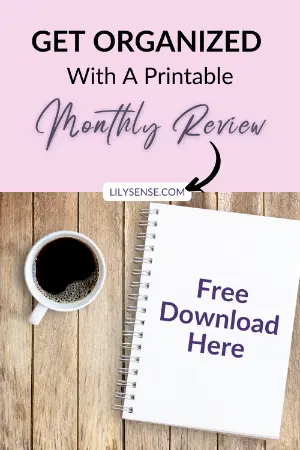photo of a table witha coffee cup on it an the notebook free download here. The caption reads get organized with a printable monthly review template
