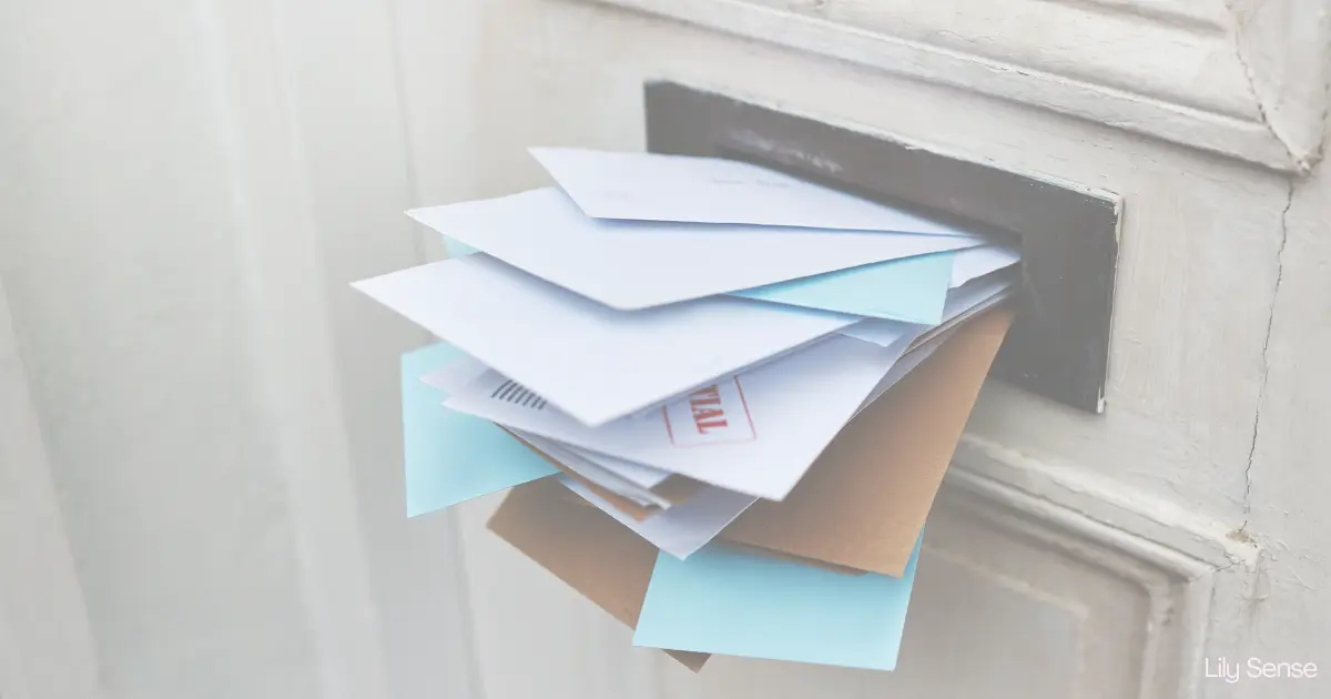 Photo of a pile of letters being pushed through a letter box