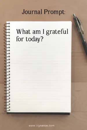 a notebook on a desk with the prompt What am I grateful for today?