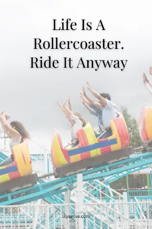 a photo of people with their hands up enjoying a rollercoaser ride with the caption. life is a rollercoaster. Ride it anyway